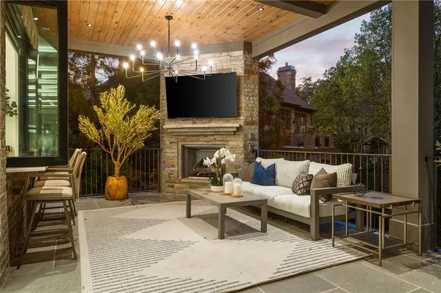 a living room with furniture a fireplace and a chandelier