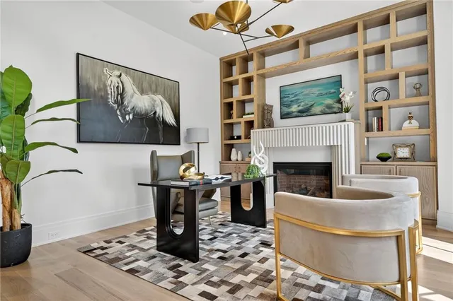 a view of empty room with wooden floor and window