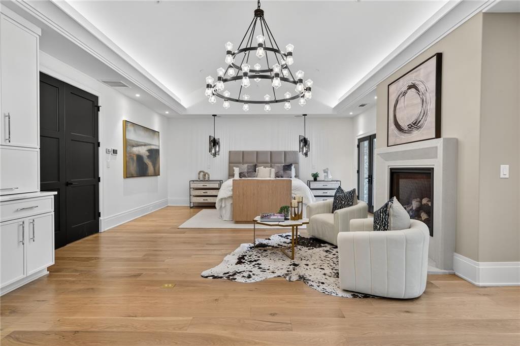 3565 Rivers Call Boulevard Atlanta, GA 30339 - Photo 22 of 78 a living room with furniture a fireplace and a chandelier
