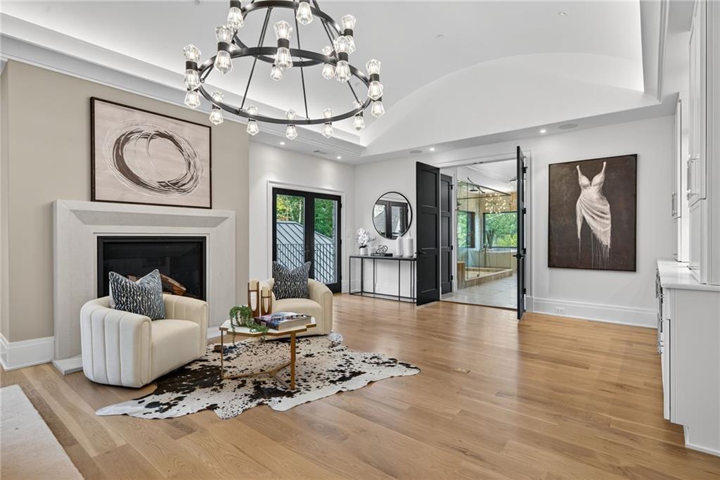 3565 Rivers Call Boulevard Atlanta, GA 30339 - Photo 24 of 78 a living room with furniture a fireplace and a chandelier