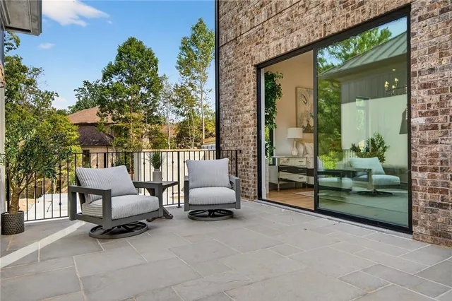a living room with furniture flat screen tv and a large window