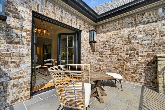 a living room with furniture kitchen view and a flat screen tv