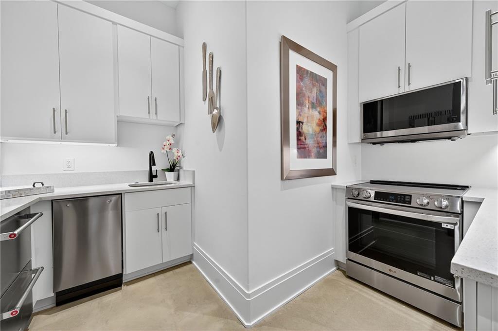 3565 Rivers Call Boulevard Atlanta, GA 30339 - Photo 66 of 78 a kitchen with white cabinets and stainless steel appliances