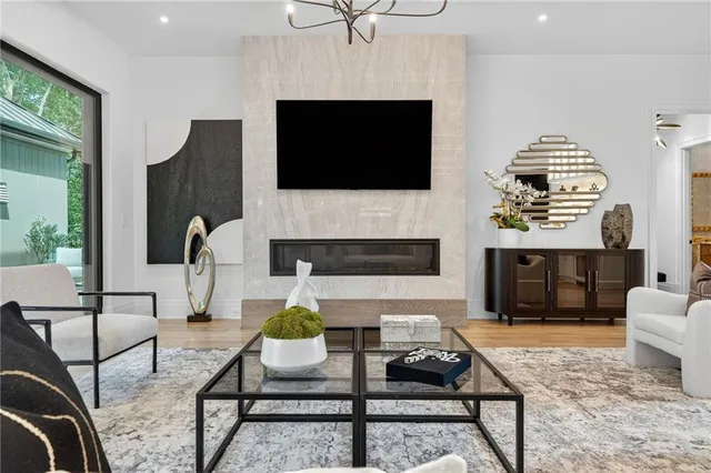 a kitchen with stainless steel appliances granite countertop a dining table chairs and sink