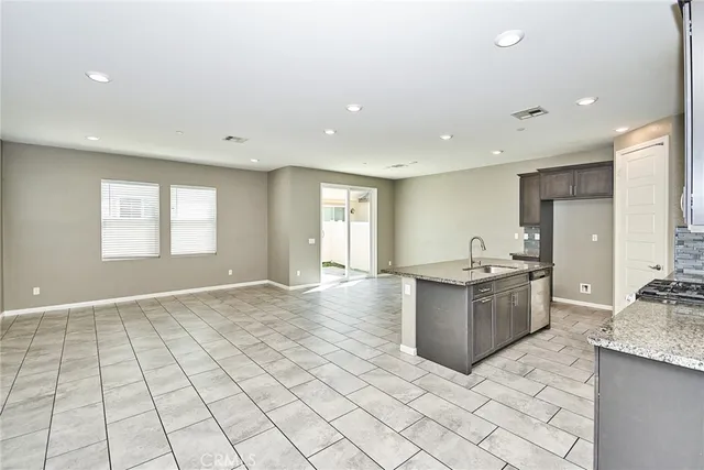 a kitchen with stainless steel appliances granite countertop a sink and cabinets