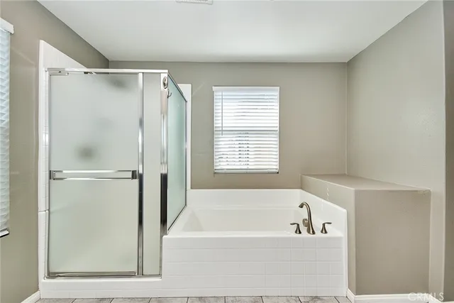 a bathroom with a bathtub and a shower