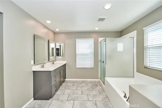 a bathroom with a double vanity sink and mirror