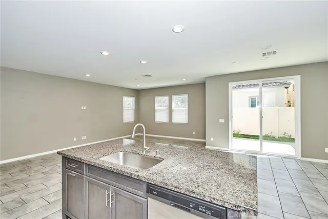 a view of a kitchen with a sink and window