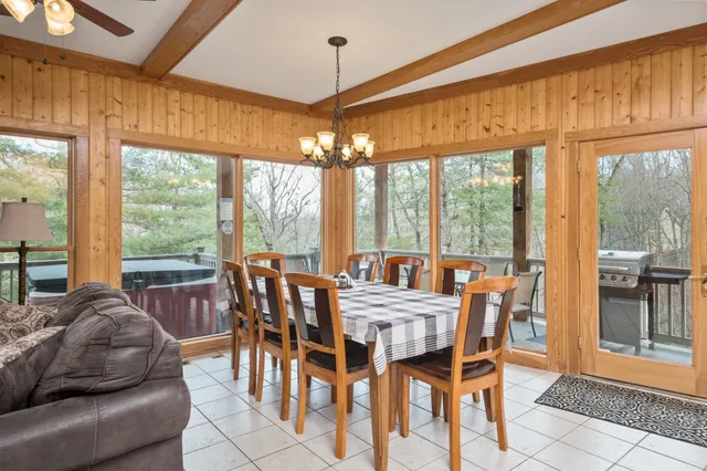 a view of a dining room with furniture large windows and wooden floor