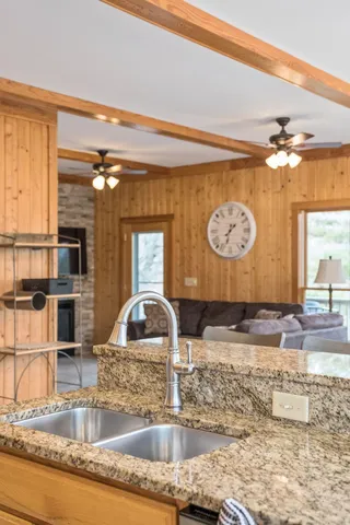 a kitchen with a sink and large window