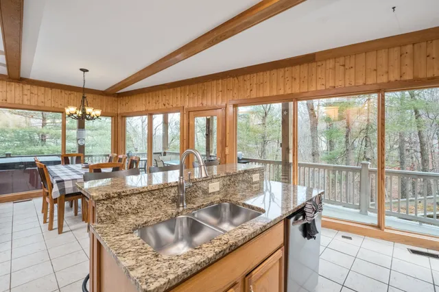 a kitchen with granite countertop a refrigerator and a sink