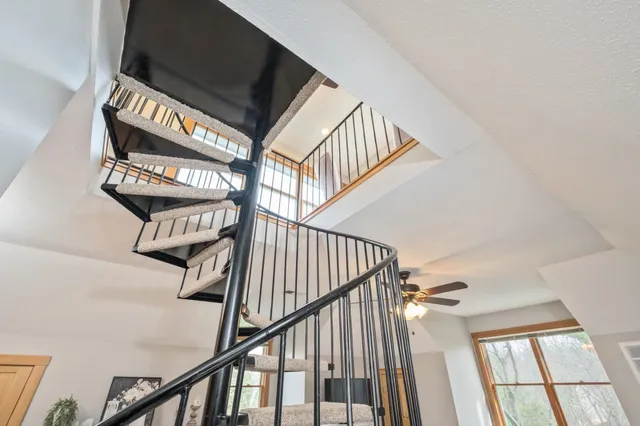 a bedroom with a bed and a flat tv screen on the dresser