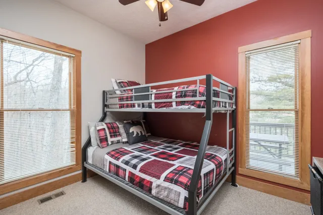 a bedroom with a large bed and a chandelier