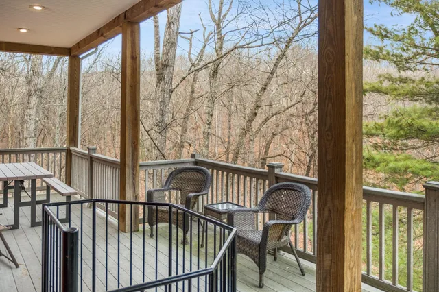 a view of a city from a balcony with furniture
