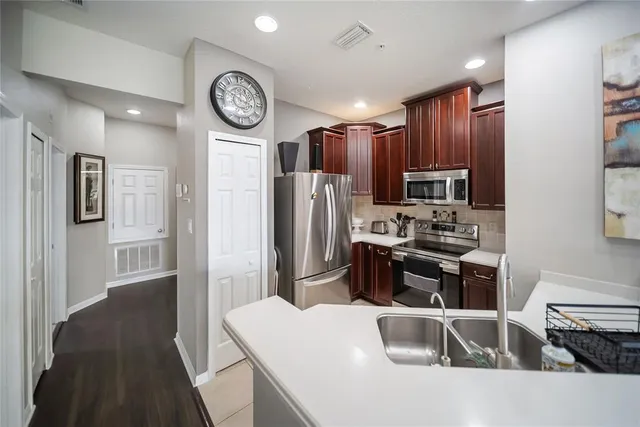 a kitchen with a sink cabinets and wooden floor