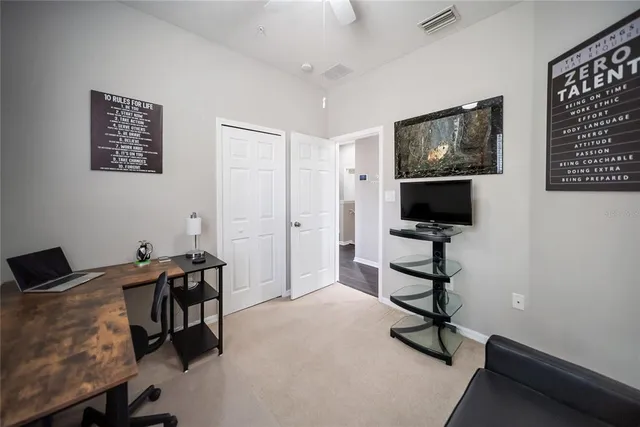a living room with furniture and a piano