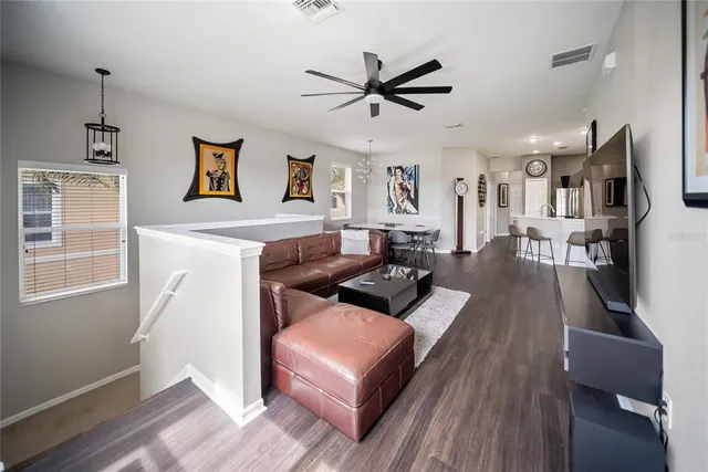 a living room with fireplace furniture and a wooden floor