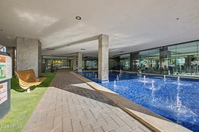 a swimming pool with outdoor seating and yard