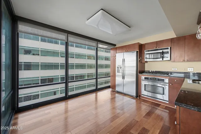a kitchen with granite countertop stainless steel appliances and cabinets