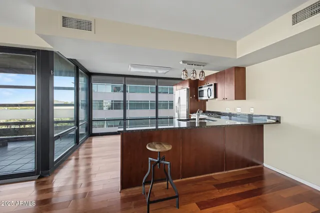 a view of a room with wooden floor and furniture