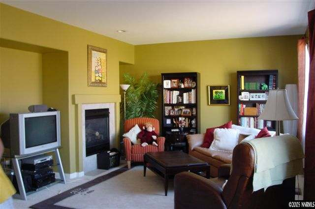 2931 Blue Grouse Drive Reno, NV 89509 - Photo 2 of 8 a living room with furniture a fireplace and a flat screen tv