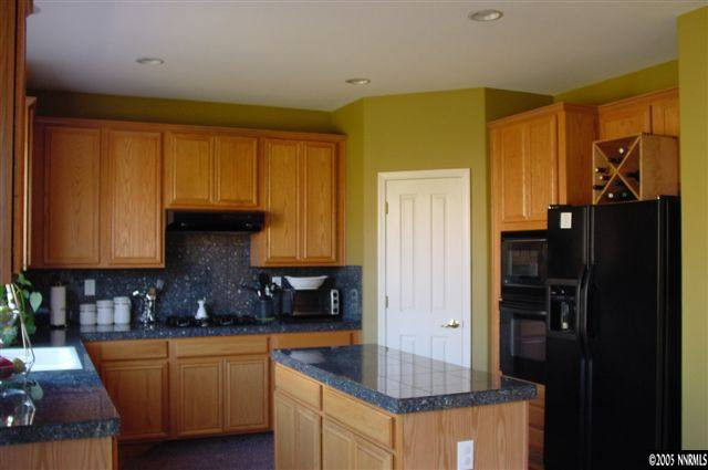 2931 Blue Grouse Drive Reno, NV 89509 - Photo 3 of 8 a kitchen with stainless steel appliances granite countertop a refrigerator and a sink