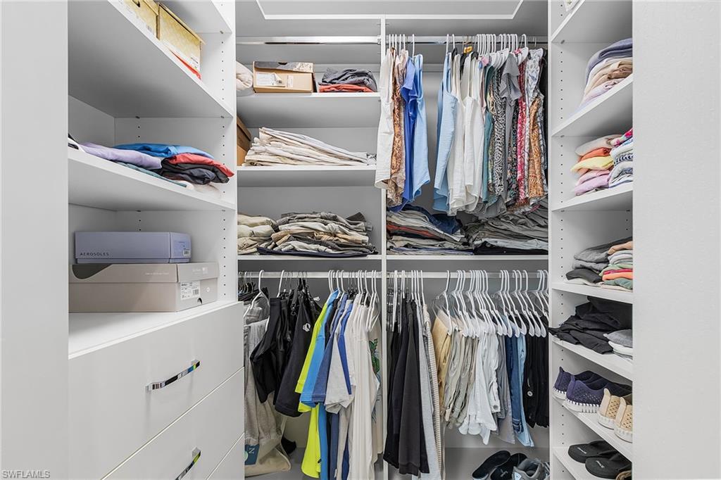 15337 Wimborne Lane, Unit 5 Naples, FL 34110 - Photo 14 of 37 a view of walk in closet with clothes and shoes