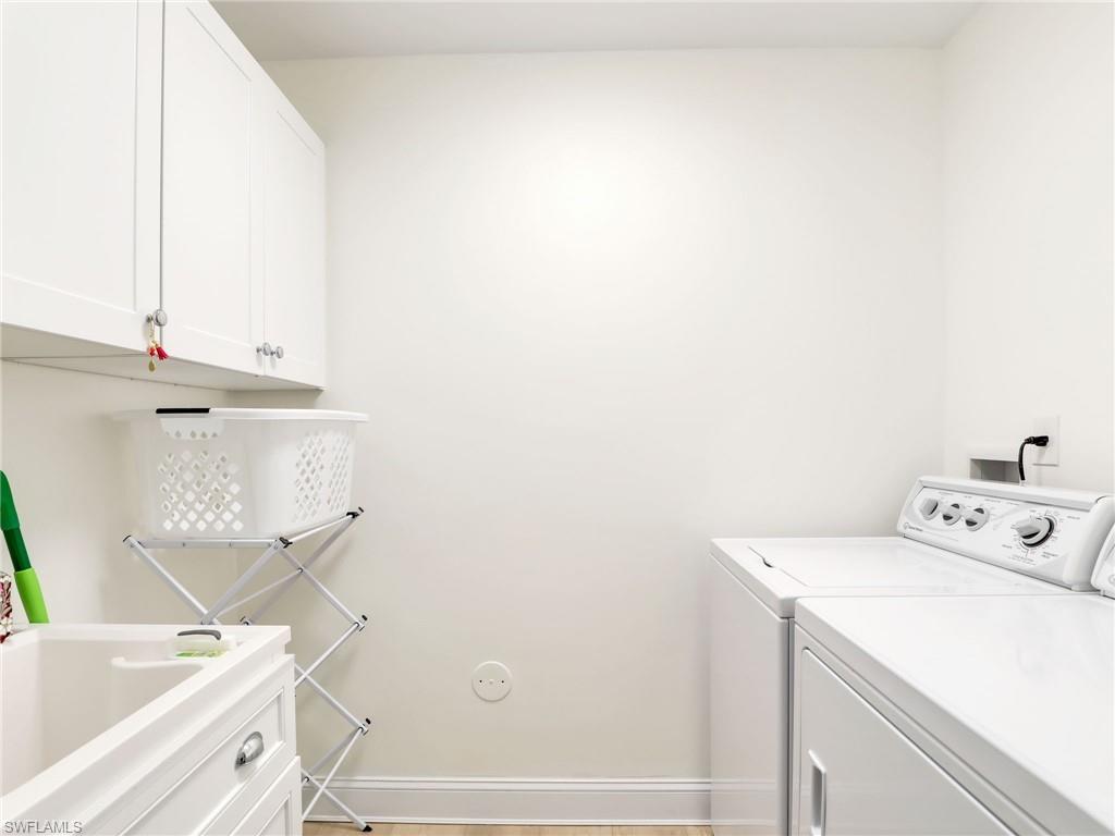 15337 Wimborne Lane, Unit 5 Naples, FL 34110 - Photo 18 of 35 Laundry with sink and cabinets
