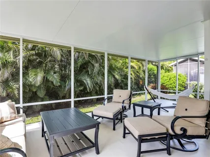 a view of a balcony with chair and table