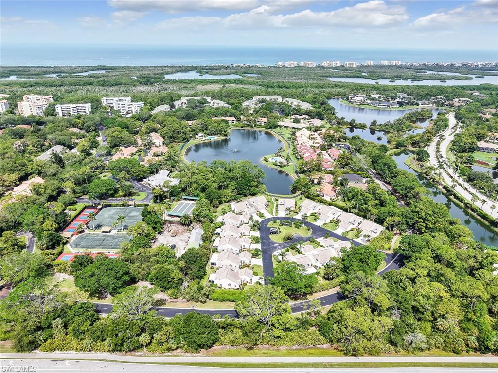 15337 Wimborne Lane, Unit 5 Naples, FL 34110 - Photo 26 of 37 an aerial view of residential houses with outdoor space and trees