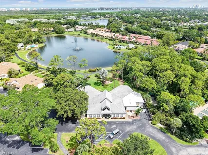 an aerial view of residential houses with outdoor space and trees