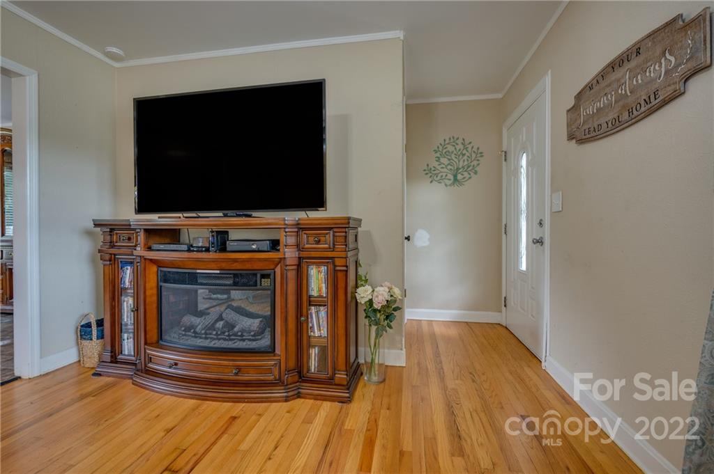 124 Crestview Street Rutherfordton, NC 28139 - Photo 5 of 28 a living room with a fireplace and wooden floor