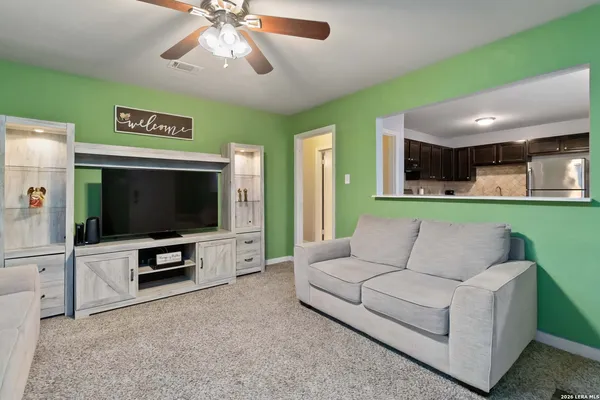 a living room with furniture and a flat screen tv