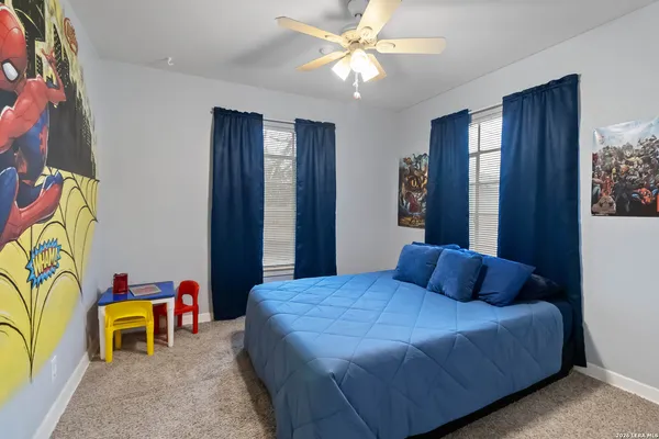 a bedroom with a bed and ceiling fan