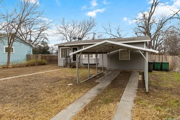 a view of a house with a yard covered in snow