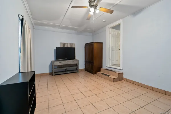 a view of room with a flat screen tv and a refrigerator