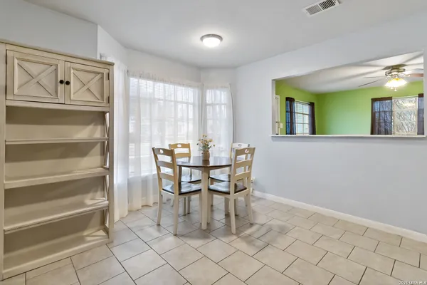a dining room with furniture and window