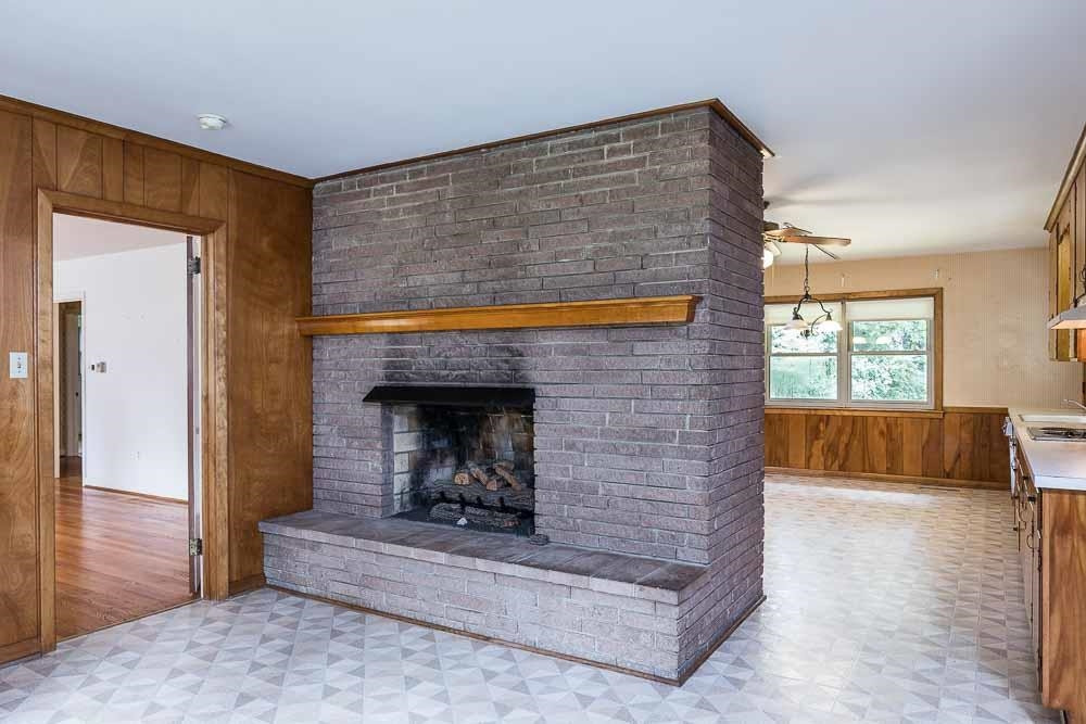 602 Wofford Road Durham, NC 27707 - Photo 9 of 26 Dramatic fireplace that separates this cozy room from the kitchen. Den