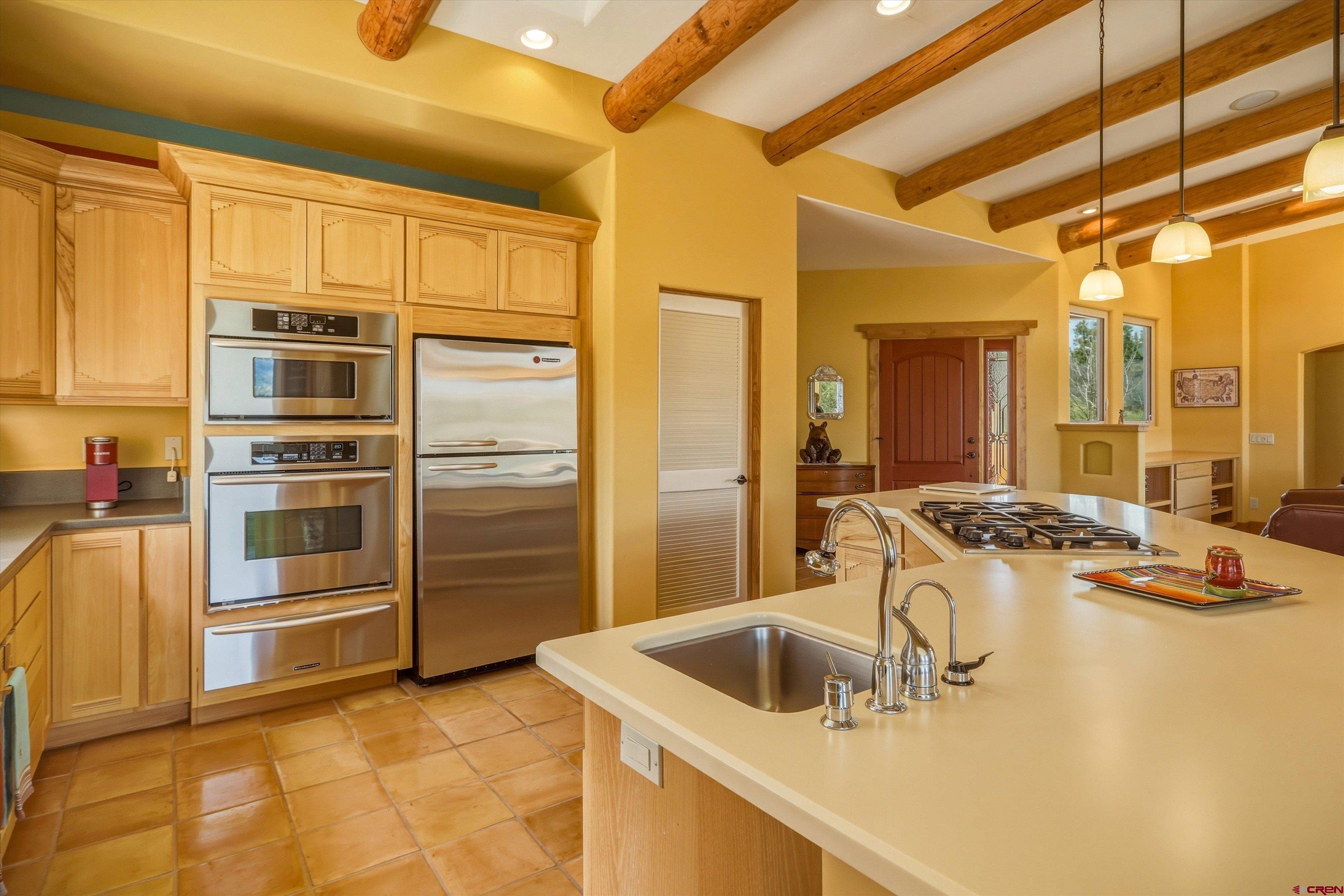 719 Spring Creek Circle Chromo, CO 81128 - Photo 11 of 45 a kitchen with stainless steel appliances granite countertop a sink and a refrigerator