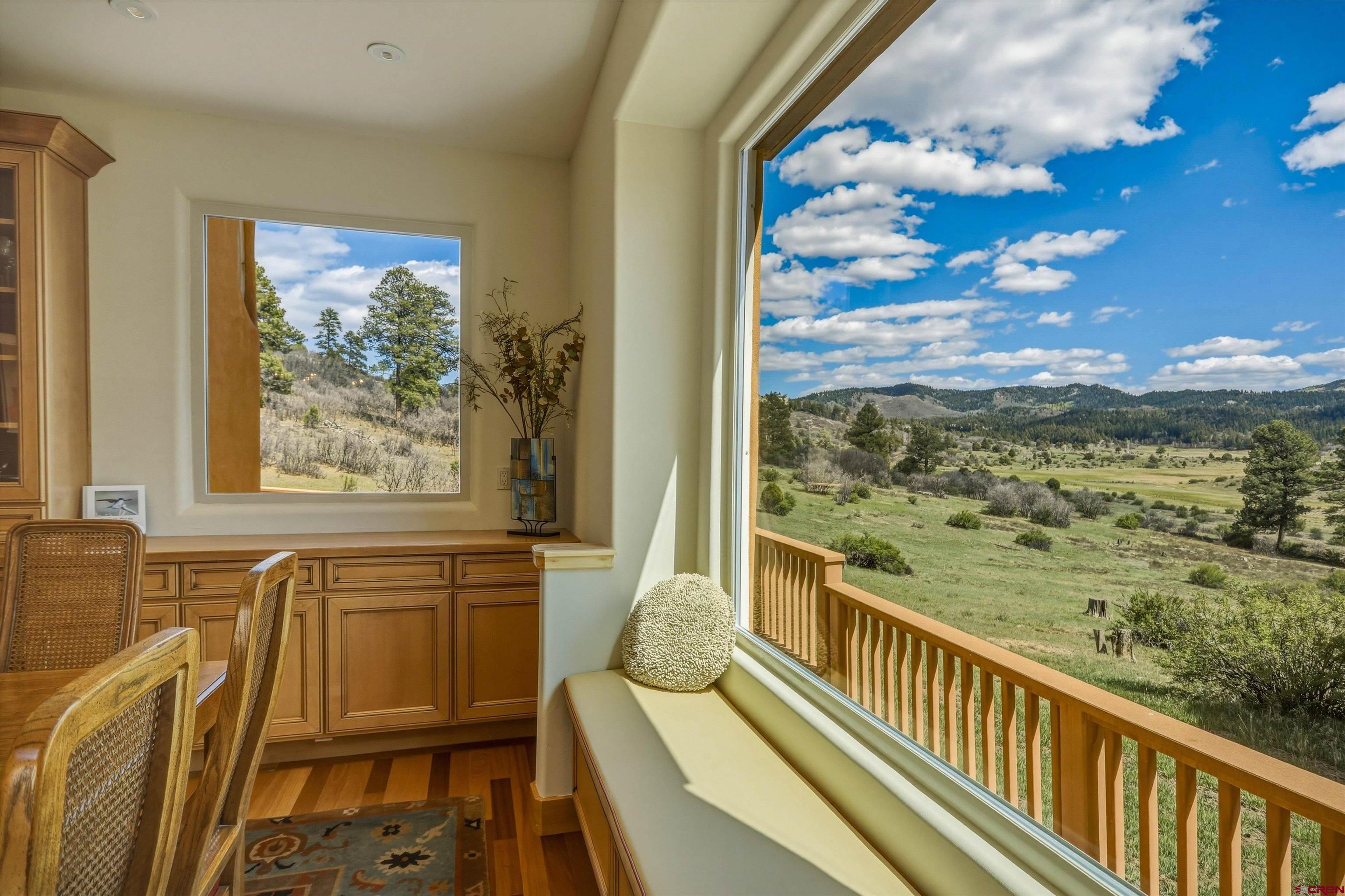 719 Spring Creek Circle Chromo, CO 81128 - Photo 12 of 45 a view of a balcony with chair and wooden floor