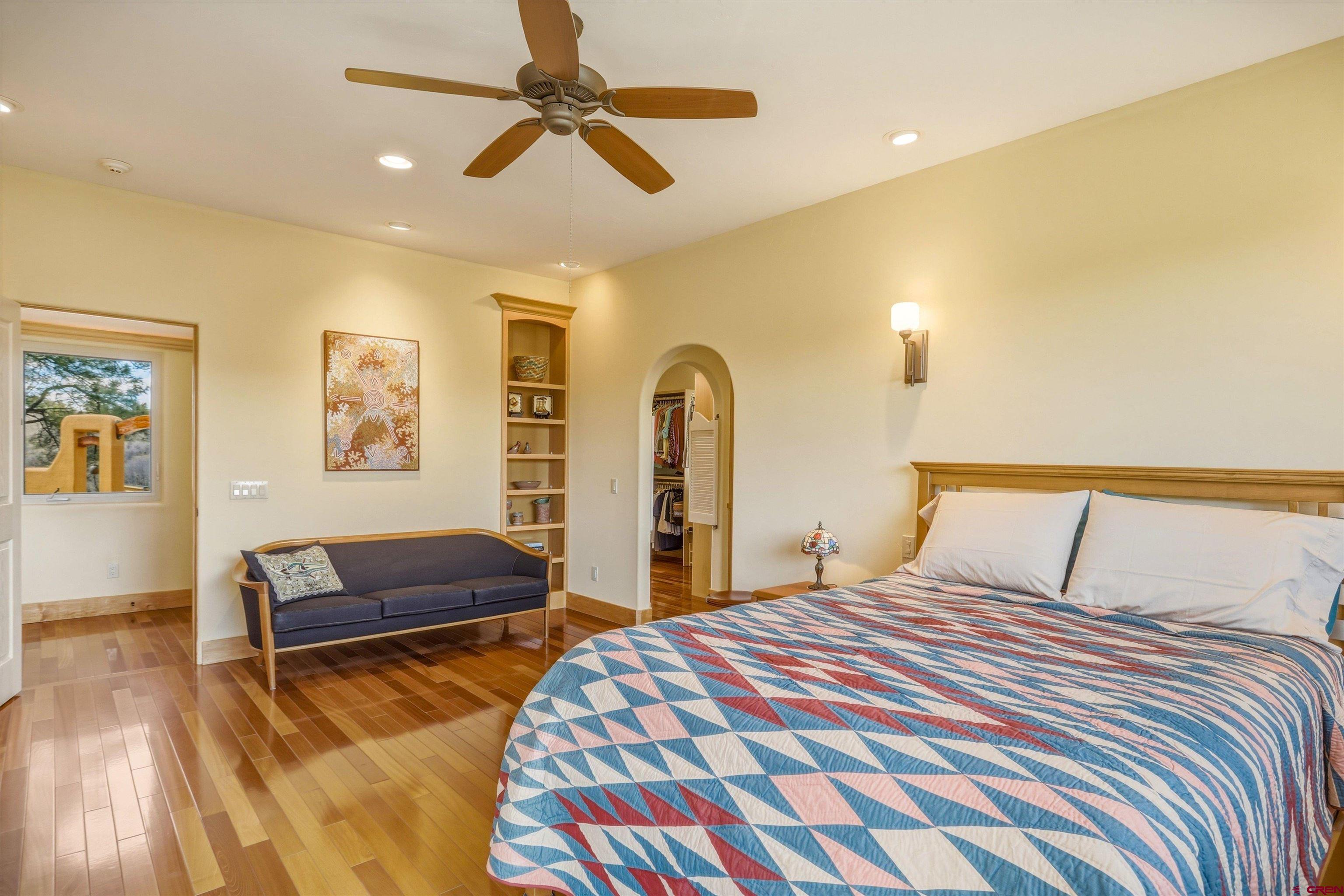 719 Spring Creek Circle Chromo, CO 81128 - Photo 15 of 45 a bedroom with a bed and ceiling fan