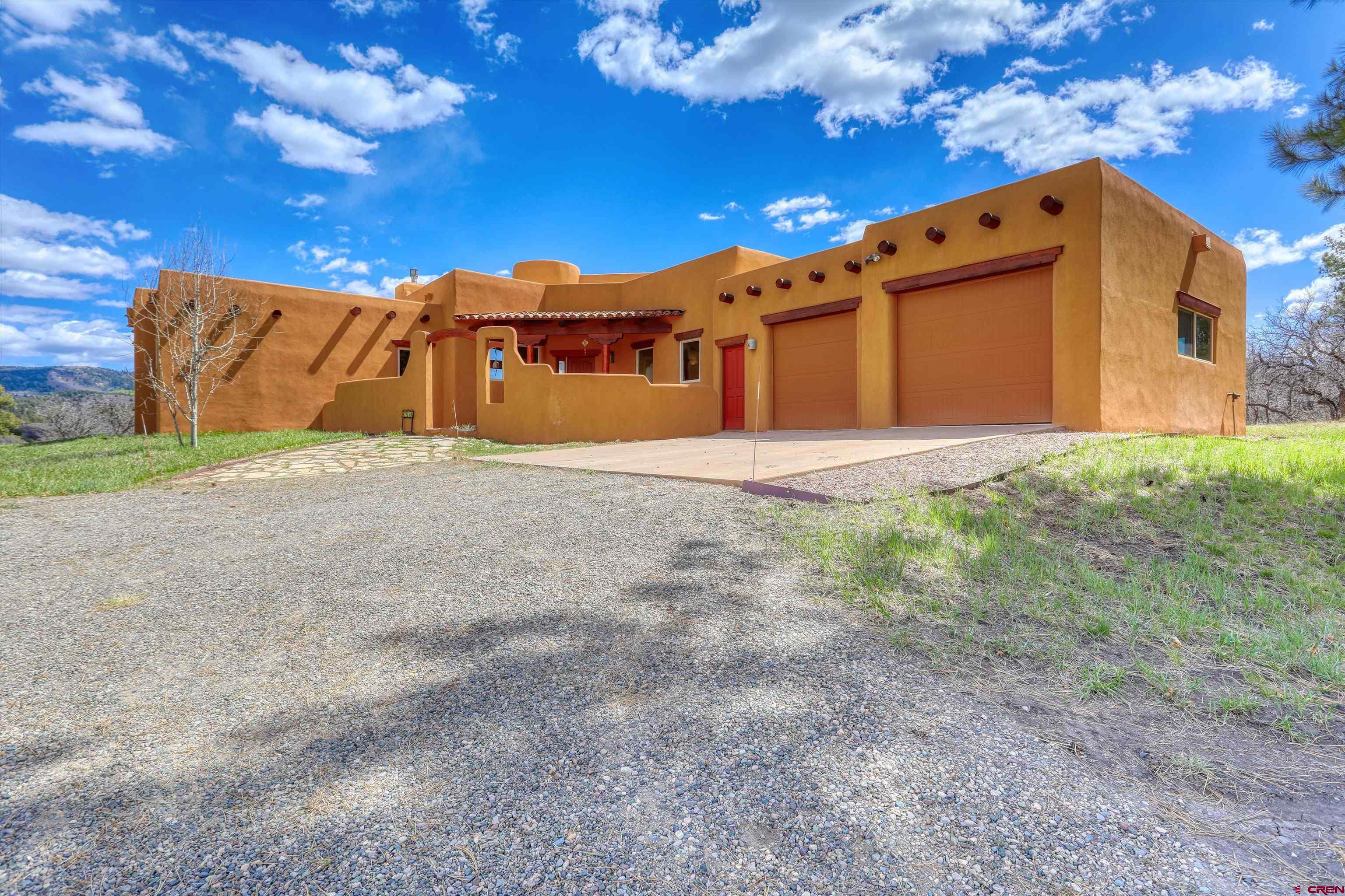 719 Spring Creek Circle Chromo, CO 81128 - Photo 2 of 45 a front view of a house with a yard
