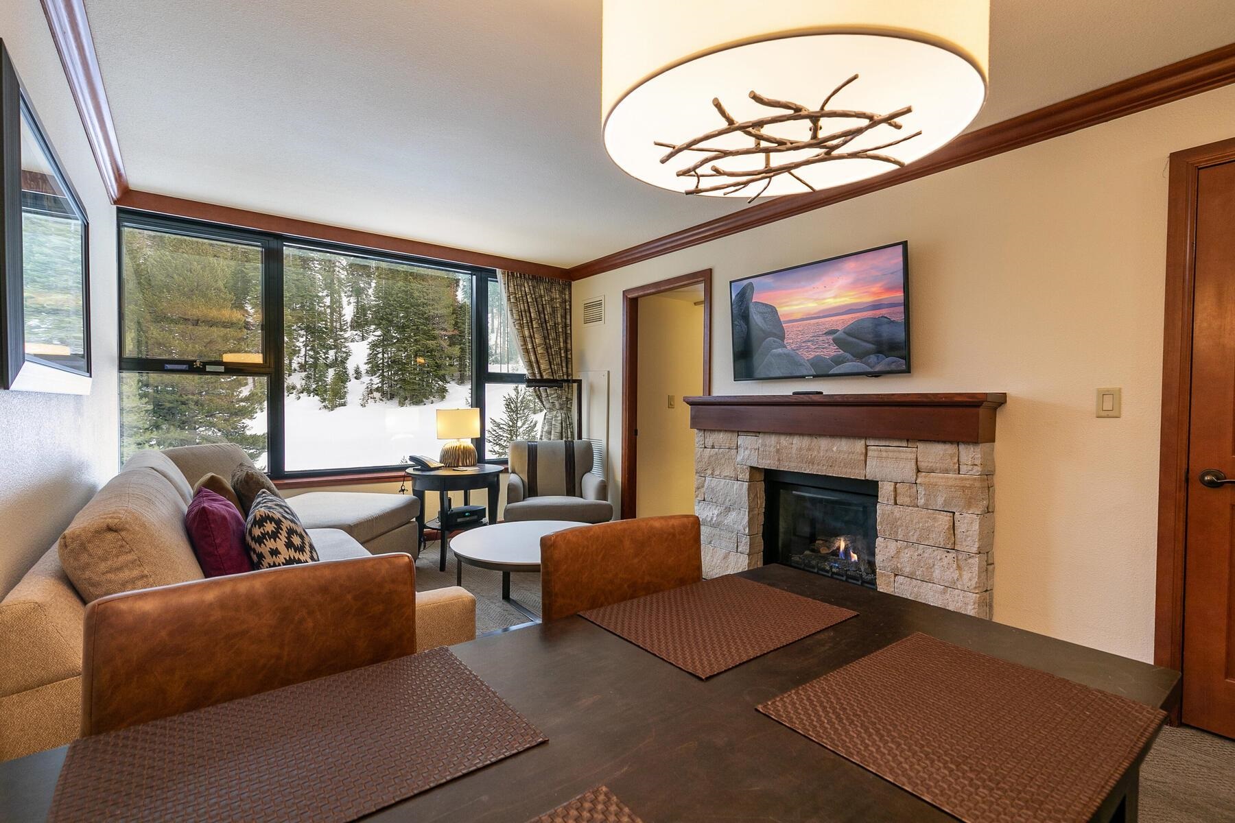 400 Squaw Creek Road, Unit 755 Olympic Valley, CA 96146 - Photo 11 of 20 a living room with furniture a chandelier and a fireplace