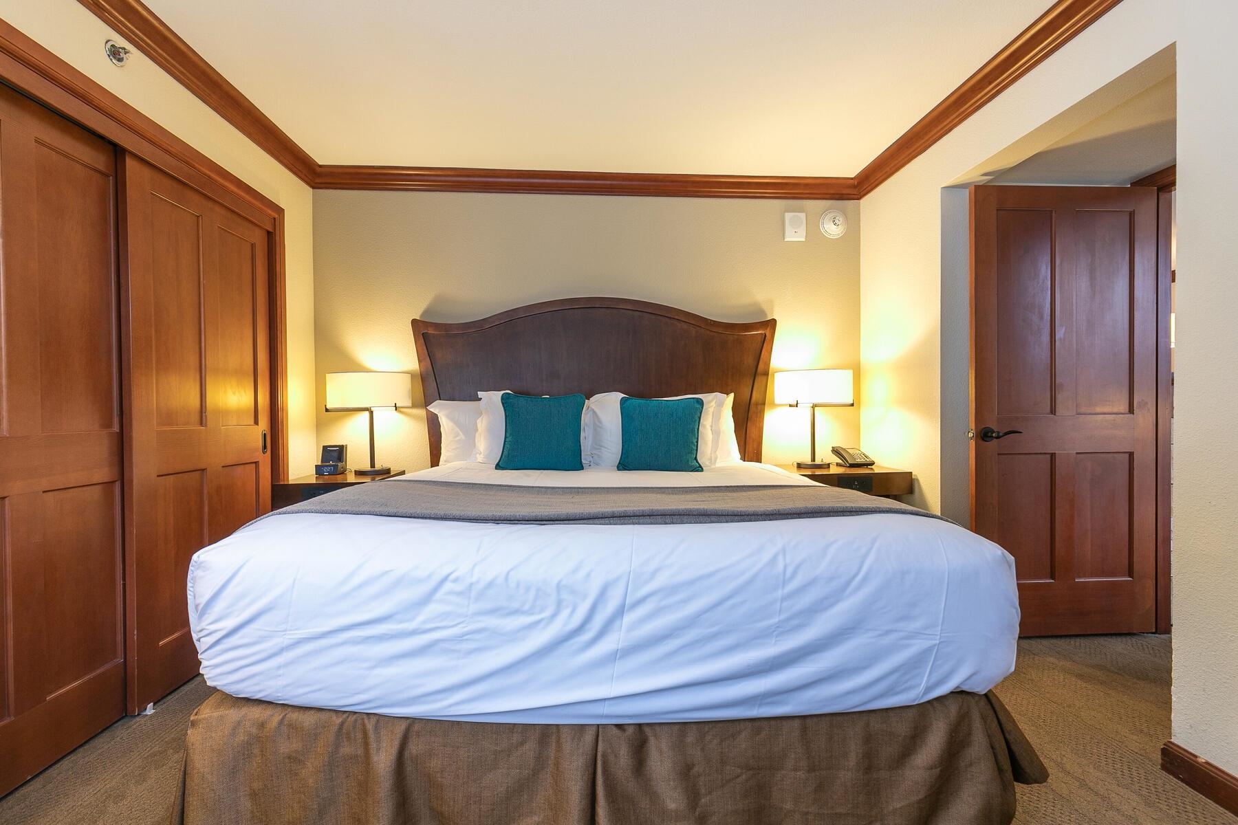 400 Squaw Creek Road, Unit 755 Olympic Valley, CA 96146 - Photo 13 of 20 a bed sitting in a bedroom next to a wooden door