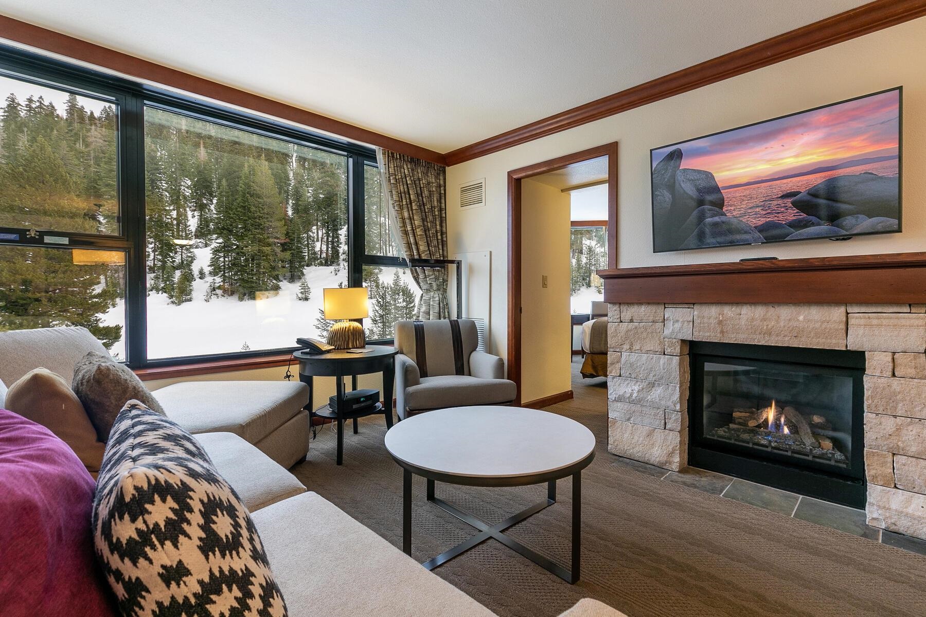 400 Squaw Creek Road, Unit 755 Olympic Valley, CA 96146 - Photo 9 of 20 a living room with furniture a flat screen tv and a fireplace