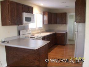 40 Substation Road Canton, NC 28716 - Photo 9 of 10 a kitchen with a sink a stove and cabinets