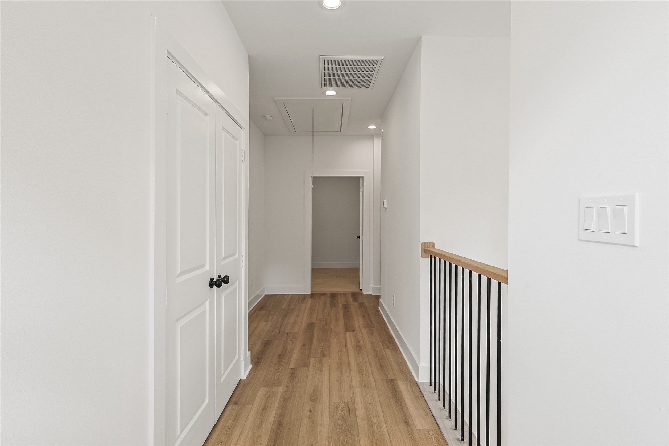 7411 Charlie Street Houston, TX 77088 - Photo 11 of 25 a view of a hallway with wooden floor and a bathroom