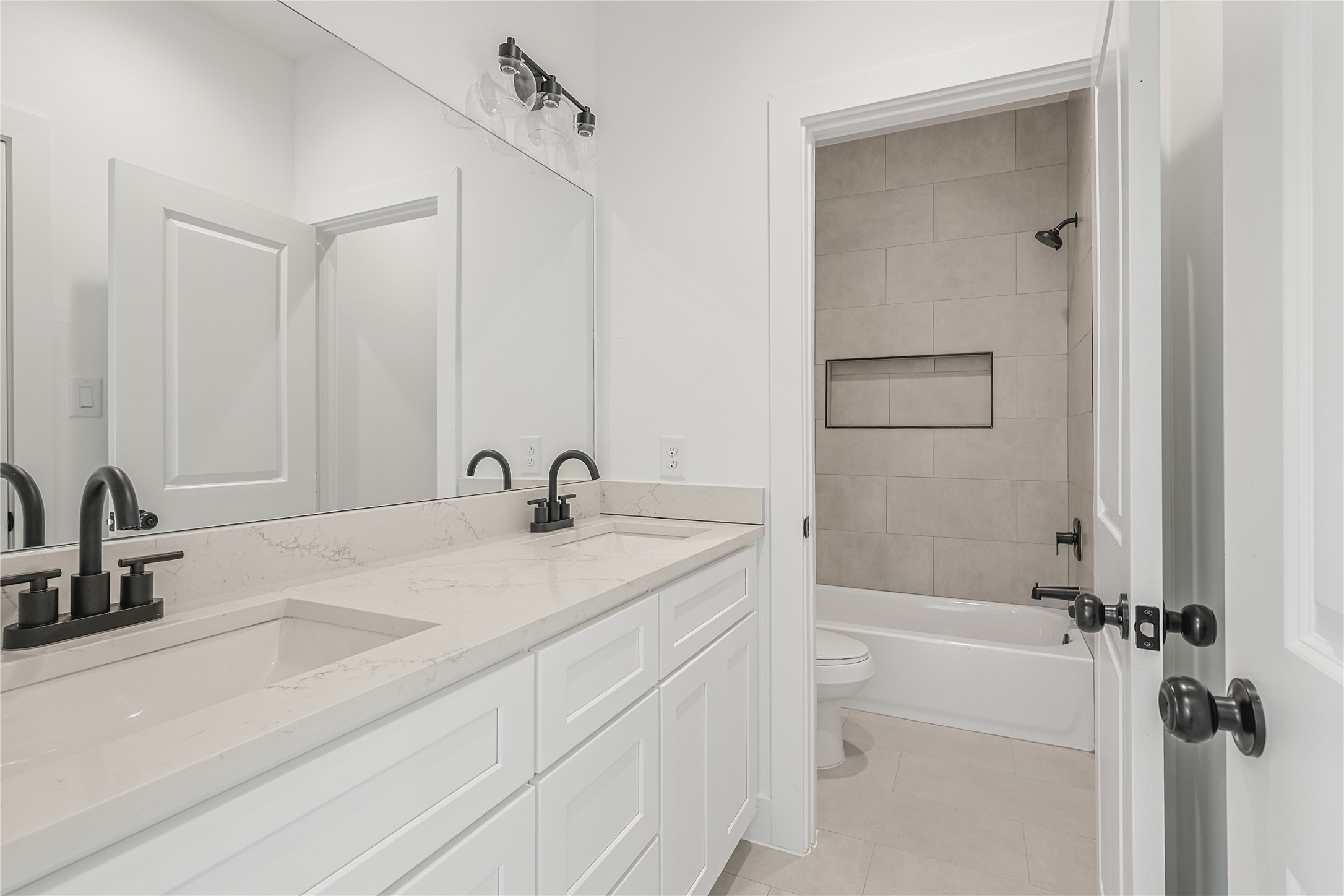 7411 Charlie Street Houston, TX 77088 - Photo 19 of 25 a bathroom with a granite countertop sink a toilet and shower