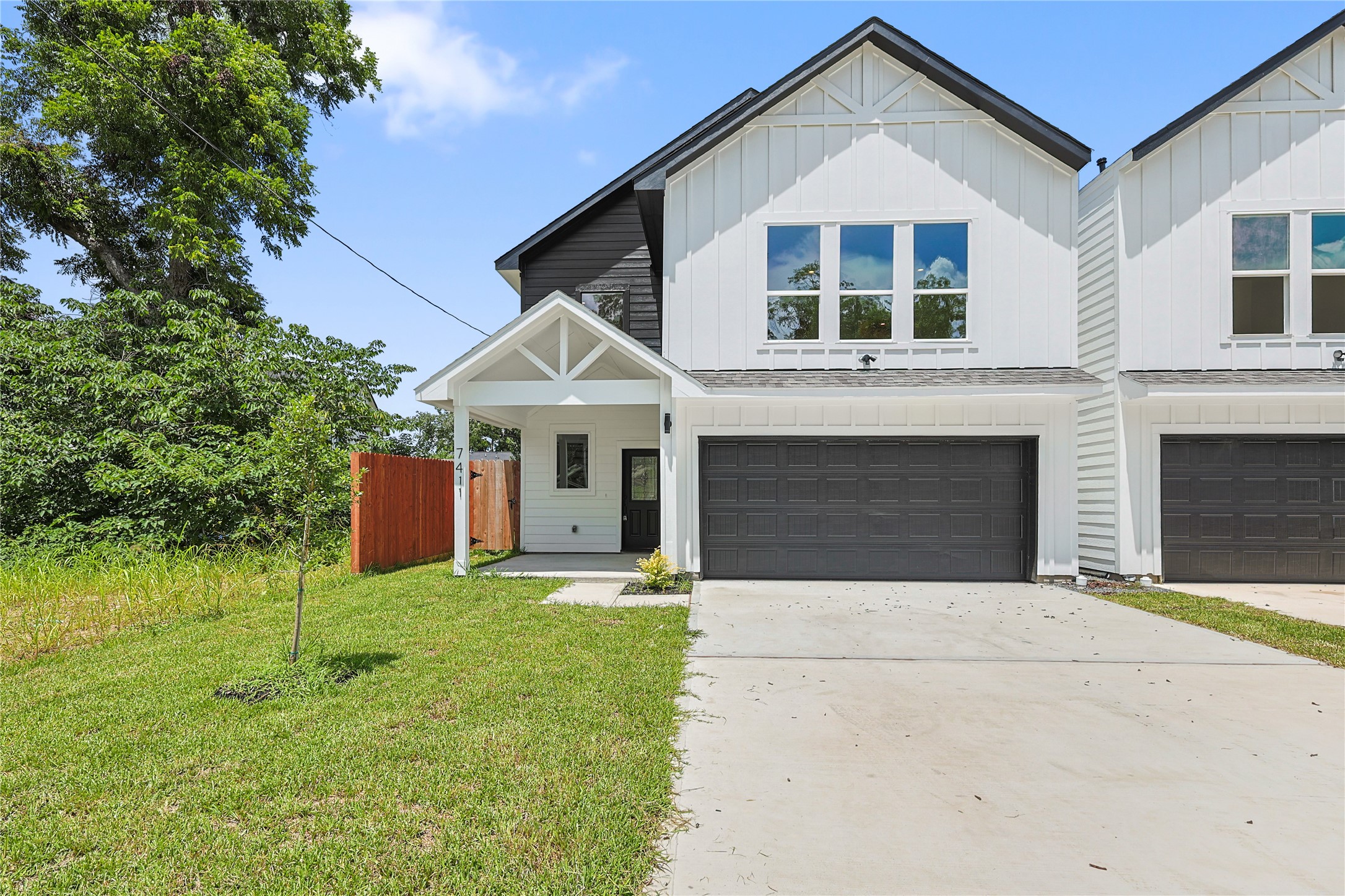 7411 Charlie Street Houston, TX 77088 - Photo 2 of 25 a front view of a house with yard and garage