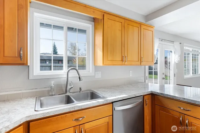 a kitchen with granite countertop a sink and a window